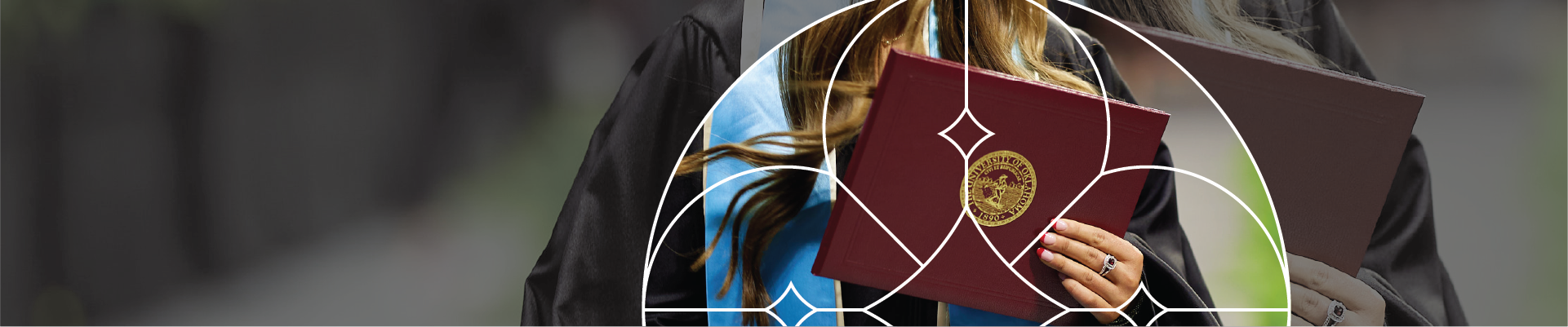 Student wearing academic regalia and holding diploma cover.