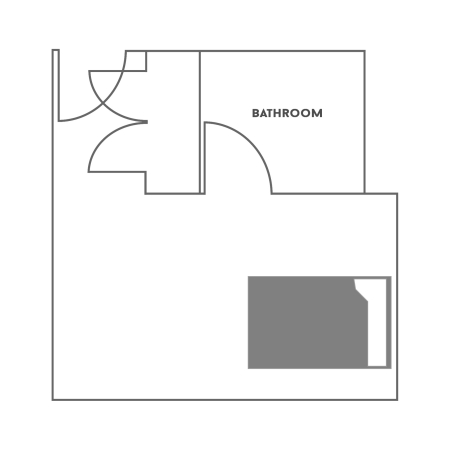 Floor plan for a One Bed with Bath in the 住宿学院. The room shows a full-size bed, a desk with a chair, a dresser and a closet. The bathroom has a toilet, sink and shower.