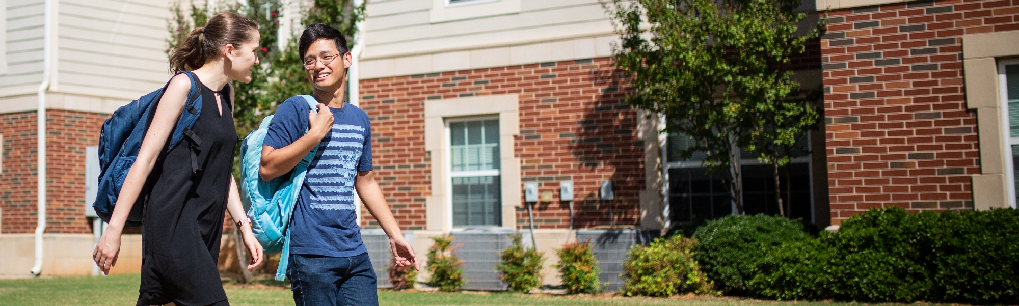 Two students walk outside of Traditions Square