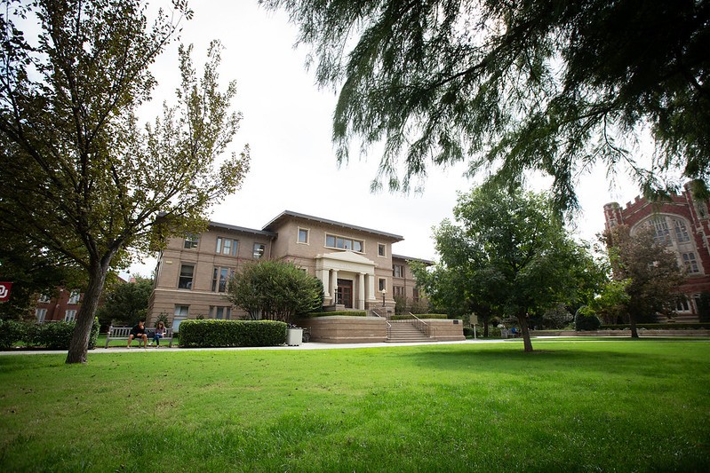 The Carnegie Building, with trees and greenery in the foregroud.