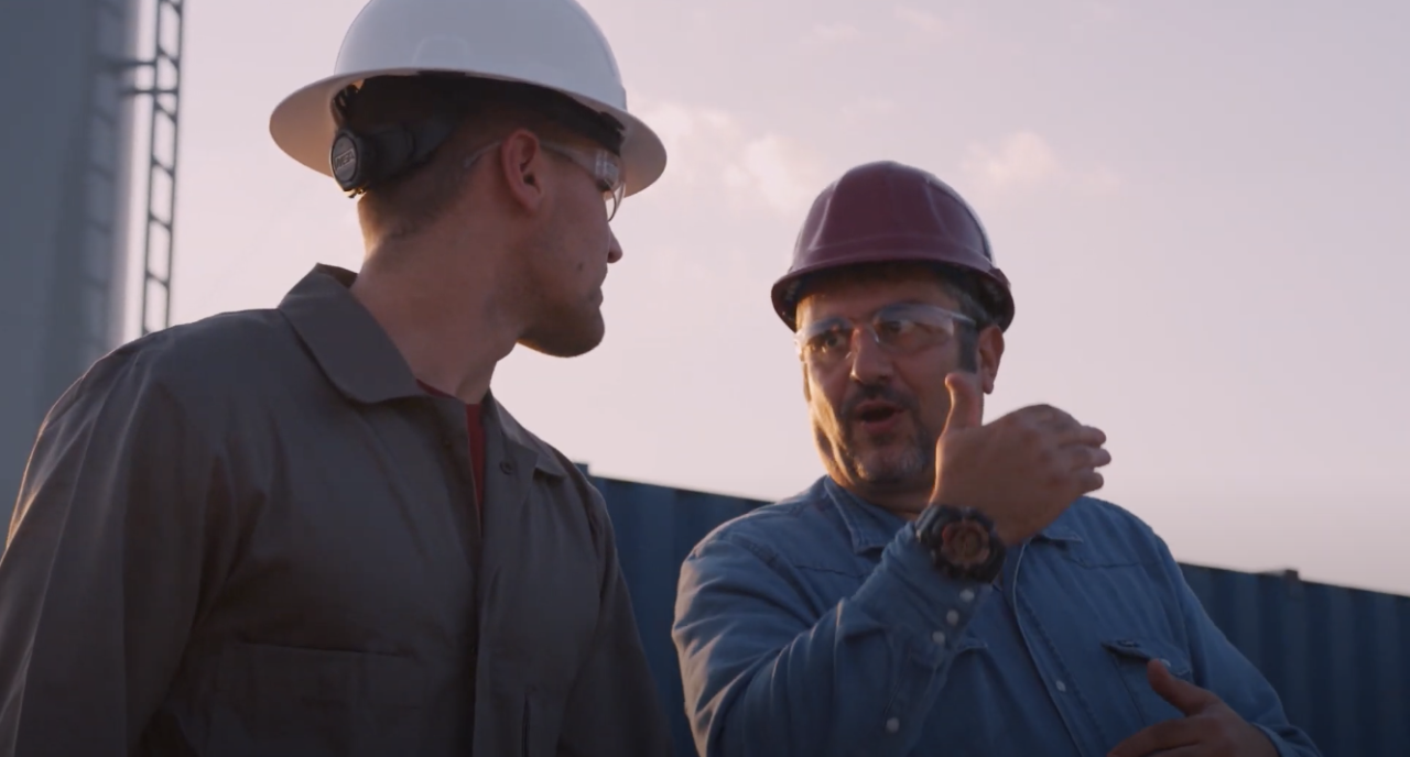 Payton and Dr. Teodoriu talking at a drill site.