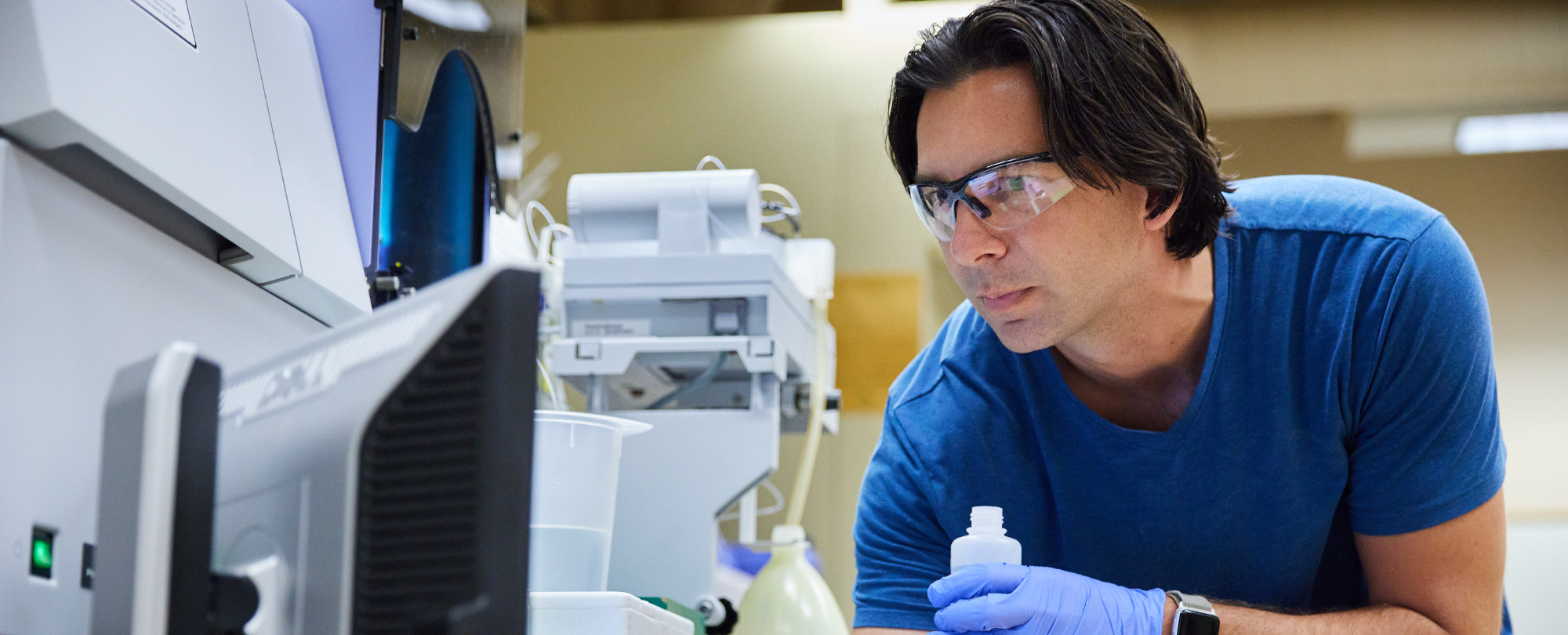 A professor and student working on a computer for research.