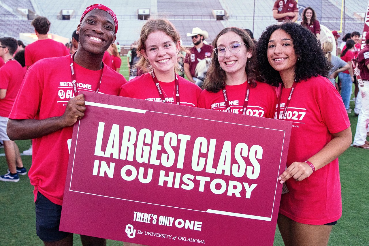 Students from the class of 2027 hold a crimson sign that says "Largest Class in OU's History" while celebrating Class Kickoff, held at the Gaylord Family - Oklahoma Memorial Stadium.