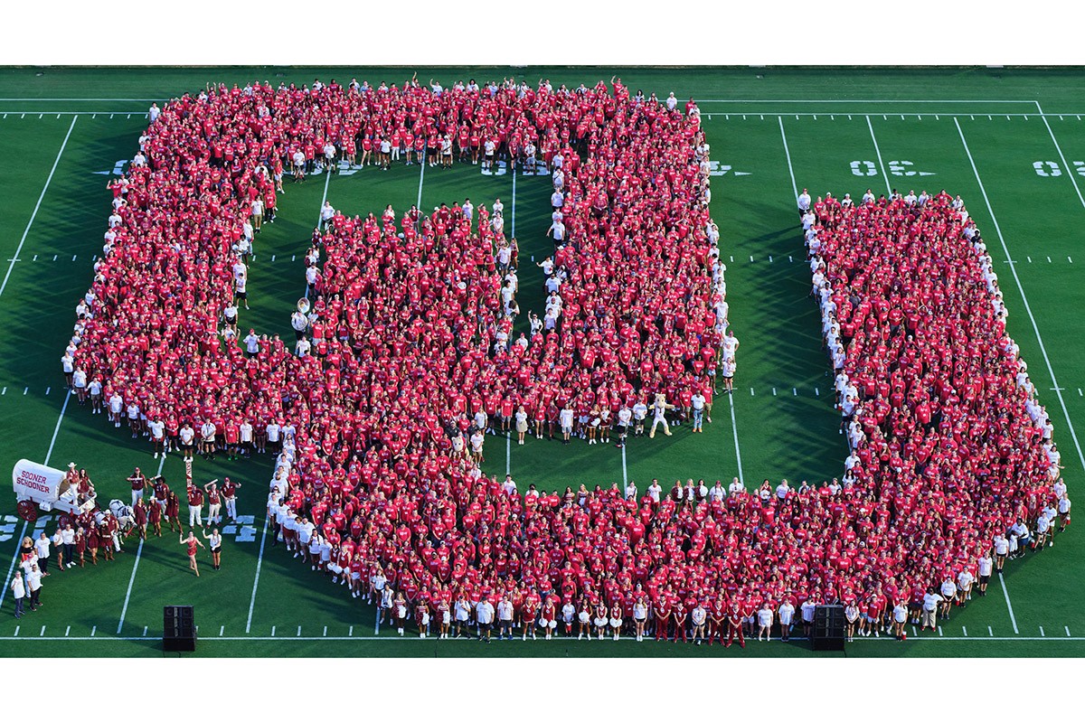 OU President Joseph Harroz Jr. joins the record-setting Class of 2027 on Owen Field for a commemorative class photo.