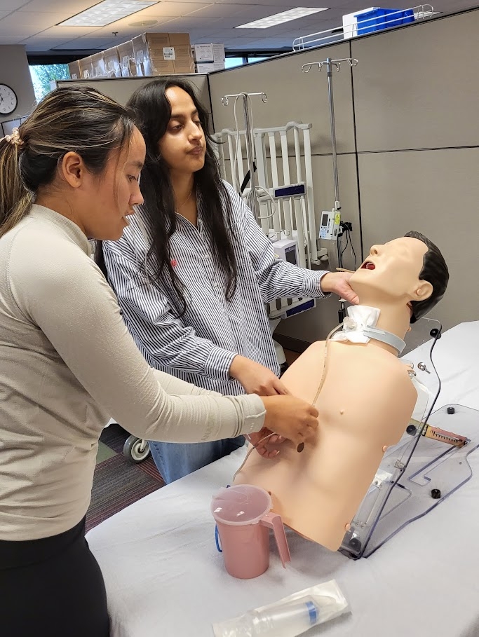 Oklahoma high school students simulating performing a tracheotomy.