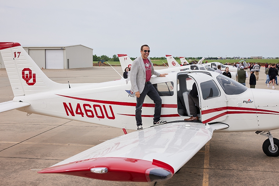 President Harroz stands on the wing of one of the new planes.