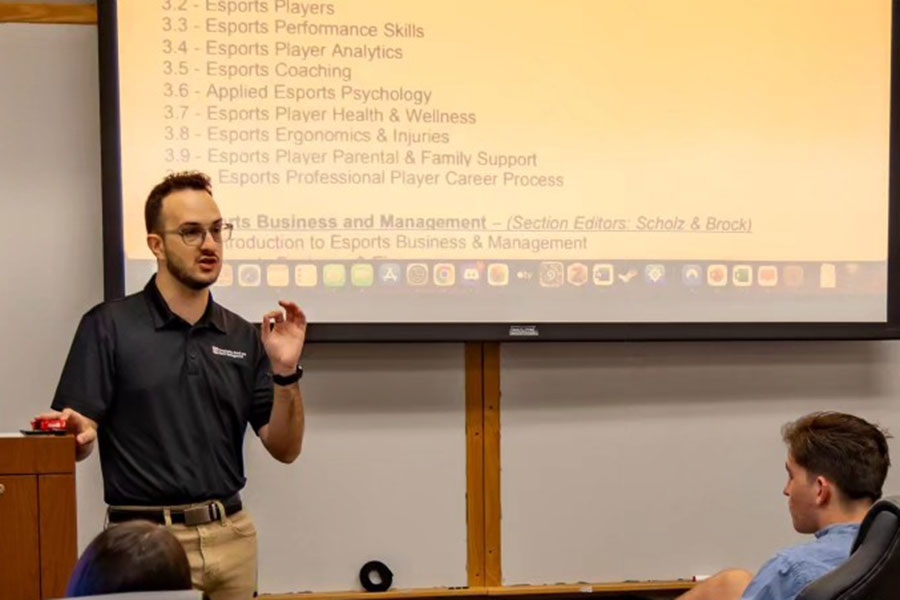 William Fisackerly lectures a classroom of students.