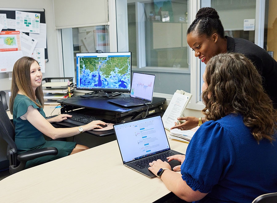 The OU SCIPP team examines flooding data on their computers.