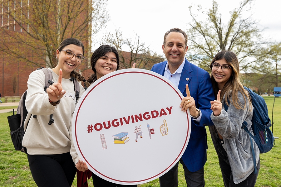 Students with President Harroz holding an #OUGivingDay sign