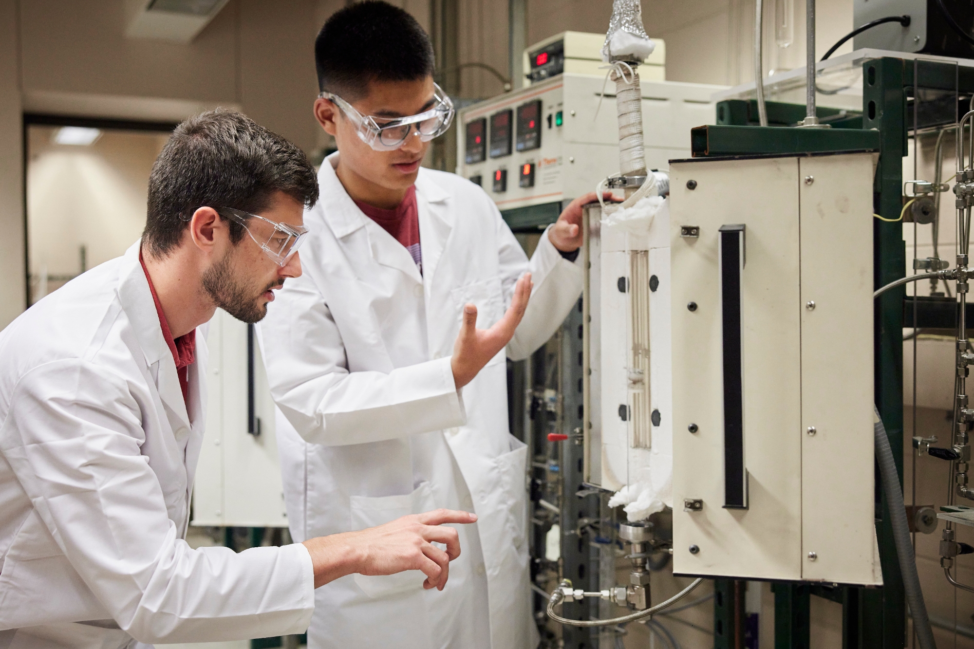Two students working in a laboratory setting.