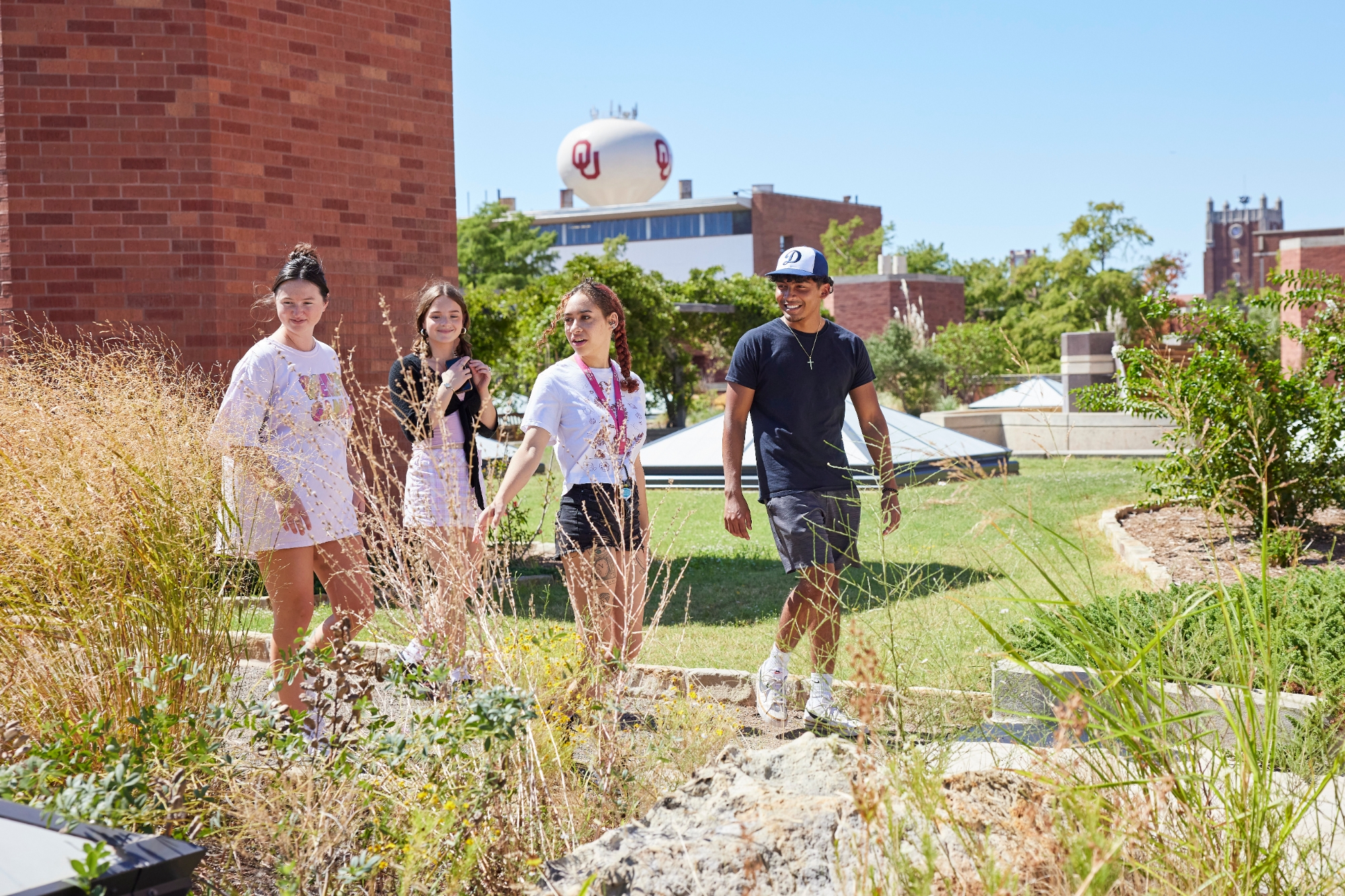 Students walking through a butterfly garden.