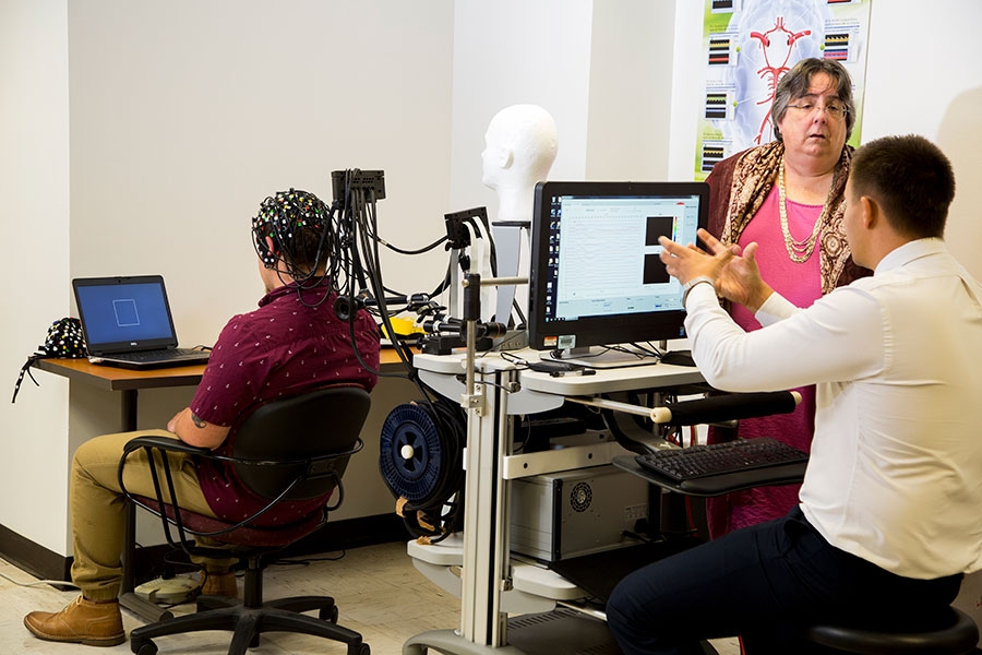Individuals conducting a cognitive test.