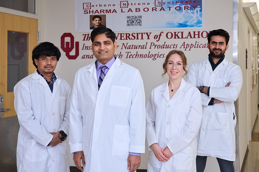 Dr. Sharma, middle, with students in his research lab.