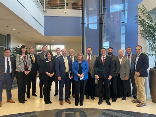 Boeing Execs stand with representatives from OADII, and OU 