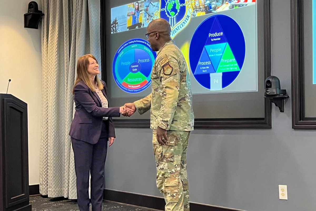 Katerina Tsetsura, Ph.D., shakes the hand of Lt Gen Stacey Hawkins