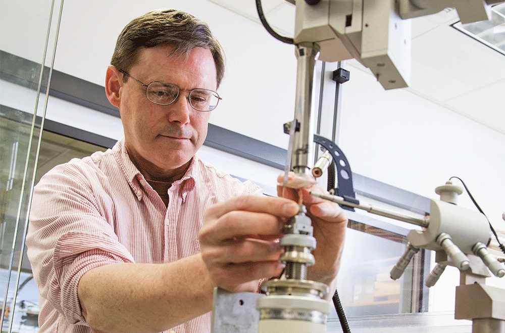 scientist adjusting piece of equipment
