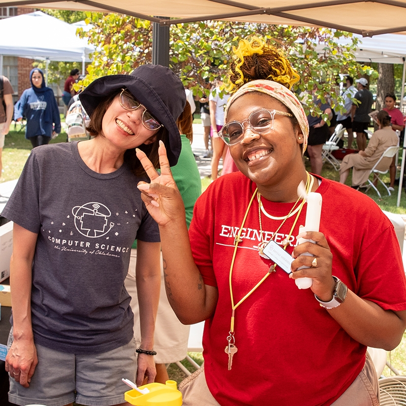 Students and staff posing at an OU event on campus.