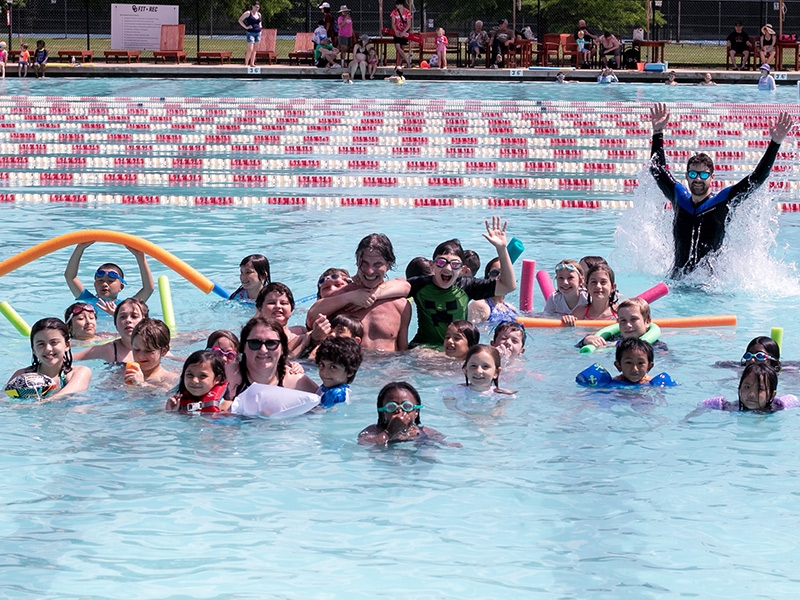 Kids and chaperones having a pool party at the OU Swim Complex.