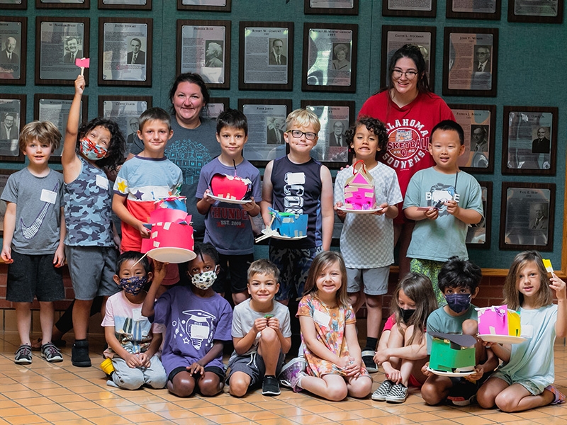 Kids showing off their paper houses.
