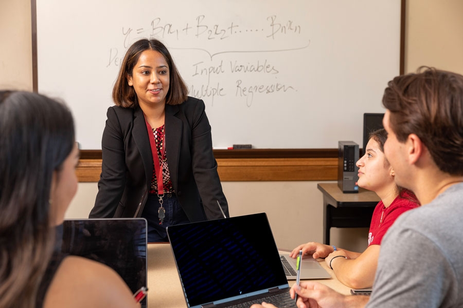 A young professor presenting their lecture to a group of students.