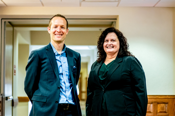 Assistant Professor of Management, and Nancy Kolwaski stand in Price Hall following a class visit on Nov. 9, 2023.