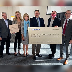 Price College staff and Weokie Federal Cedit Union present a donation check to Dean Phelps 