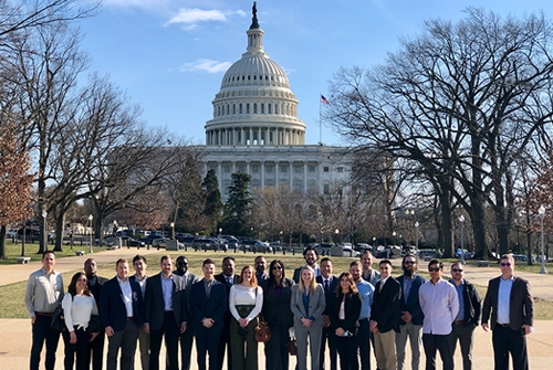 Aerospace and defense cohort take a group photo standing in front of the Oklahoma capital.