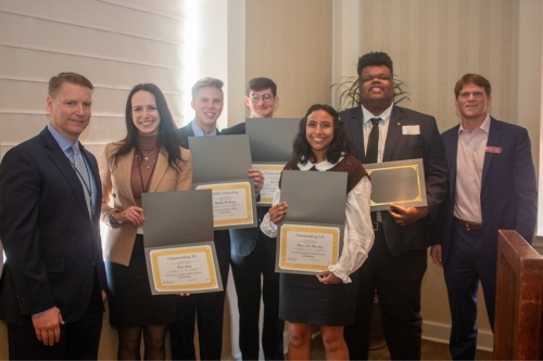 A group of MIS students take a group photo showing off  their awards at the CMISS spring retreat