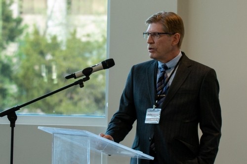a man standing at a podium in front of a microphone