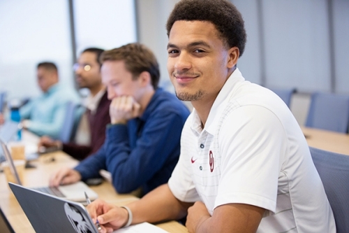 A goup of students working on laptops