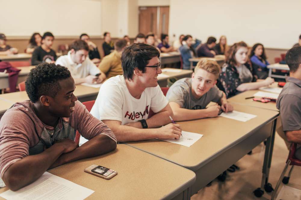 Three students sitting in class