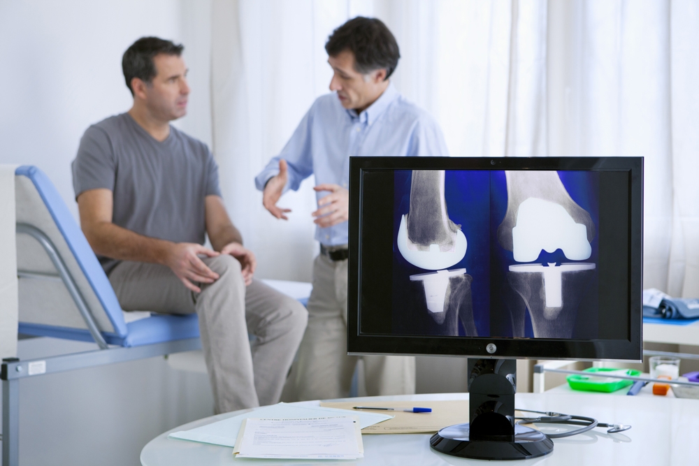 Man at doctor with knee problems