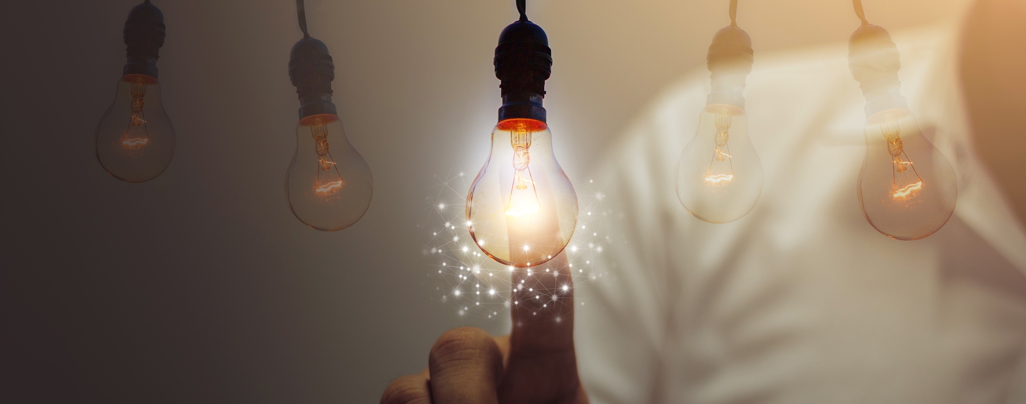 person touching light bulb