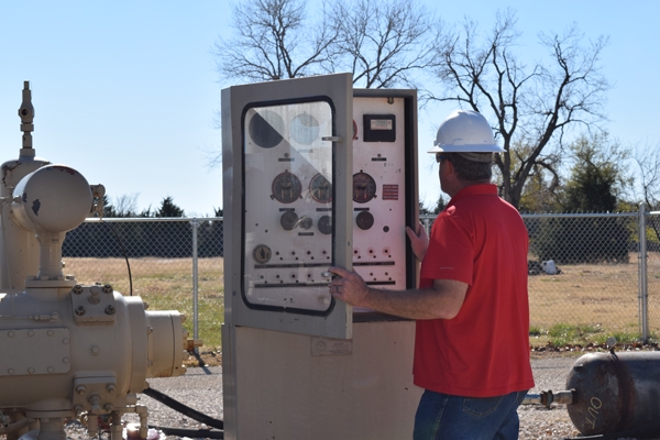 Researcher Scott Rosser looking at a control box