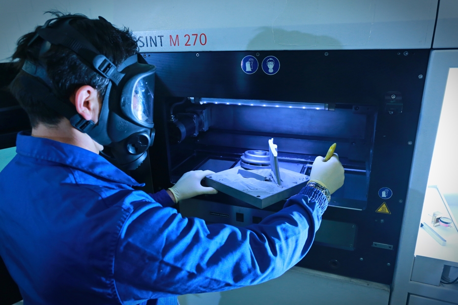Engineer working on metal 3d printer.