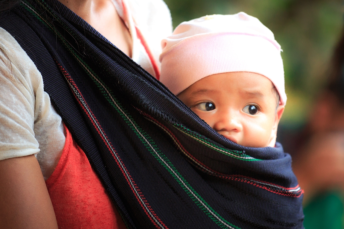 Baby swaddled in mother's arms