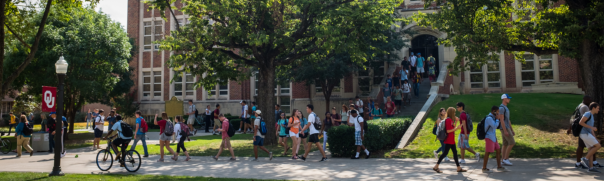 Students walking and biking on the University of Oklahoma Norman campus.