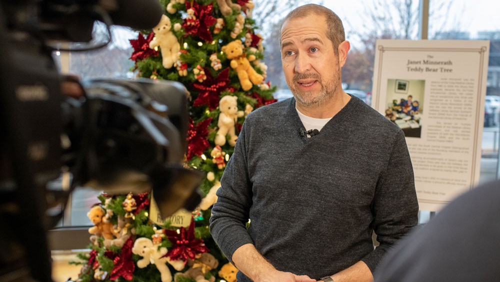 Schusterman Library Director Stew Brower being interviewed by the media for Teddy Bear Tree 2022