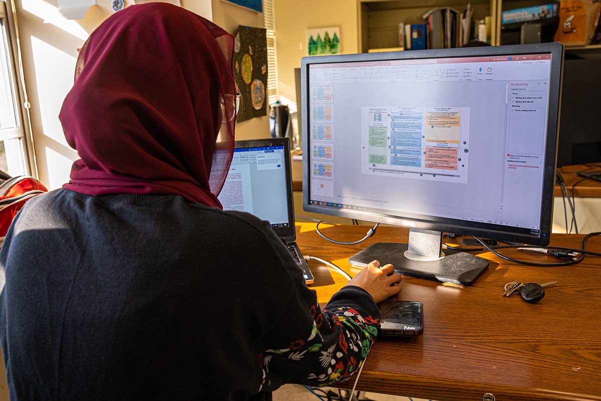 Student sitting in front of computer monitor
