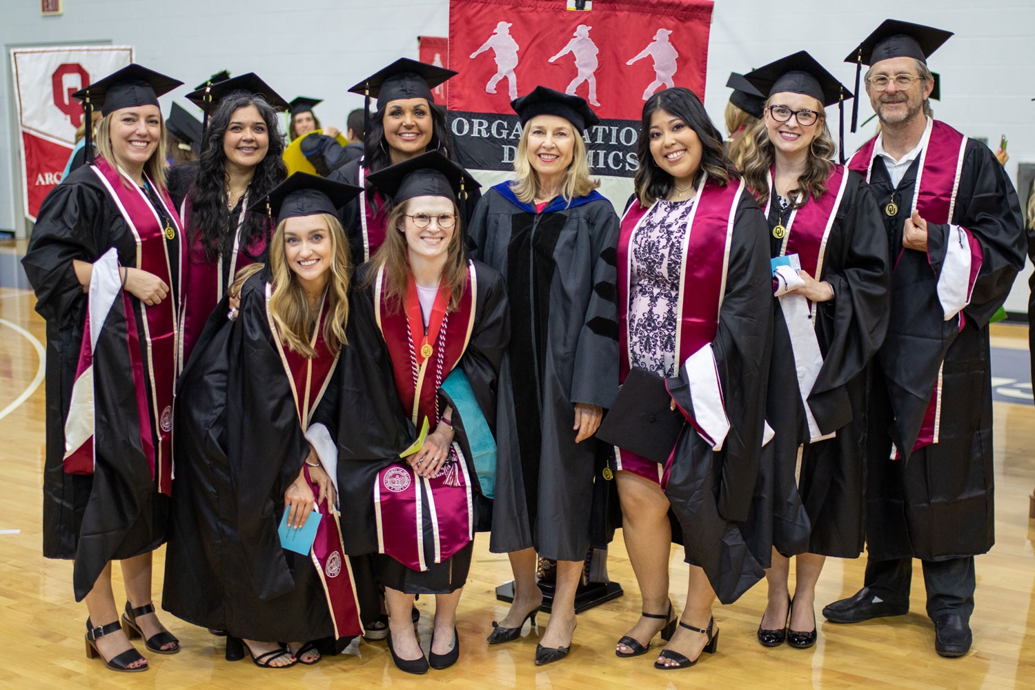 A group of ODYN graduates pose with a professor at graduation