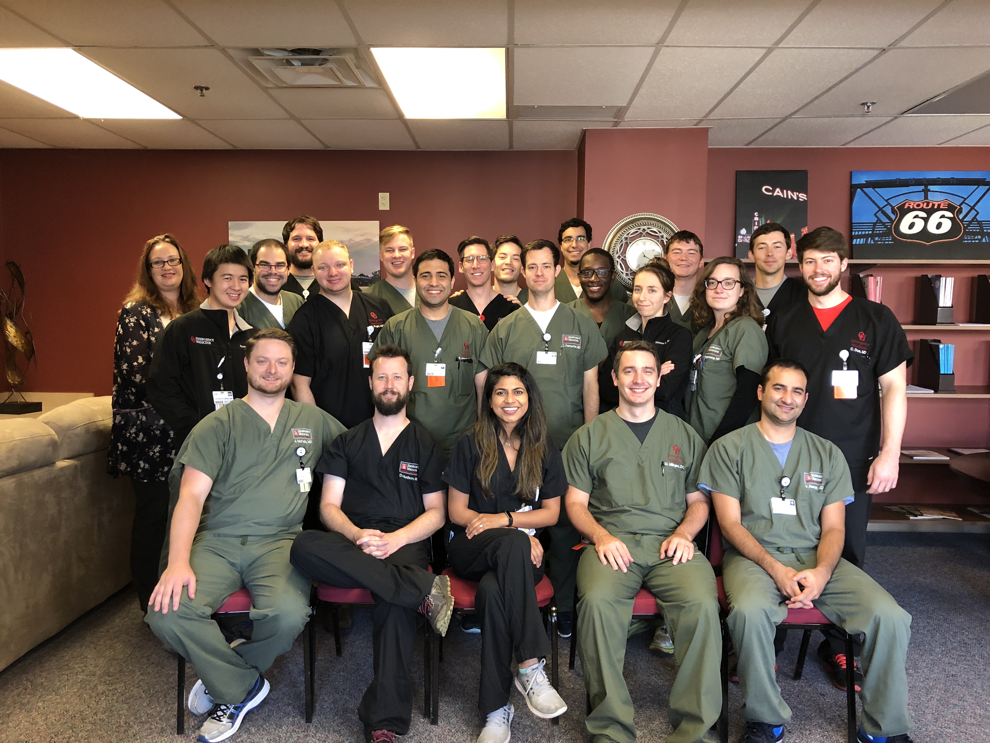 A large group of people in scrubs gather for a group photo.