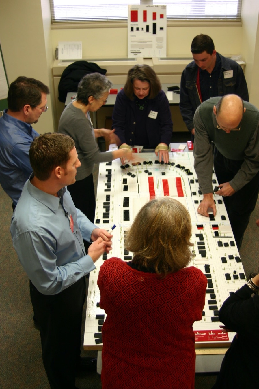 Urban design students stand around a schematic